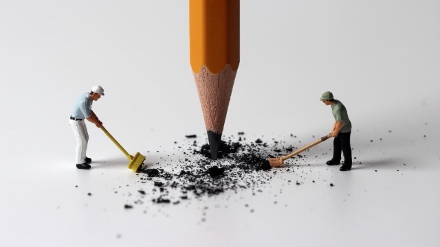 Firefly-3-small-sweeper-men-cleaning-up-pencil-shavings-from-a-huge-pencil-pointing-downwards-verti.jpg